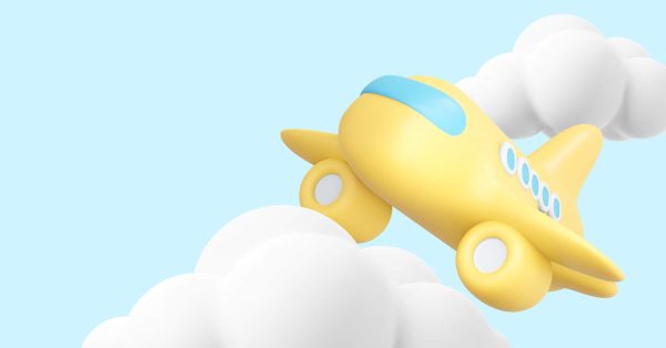 a yellow toy airplane flying through the clouds